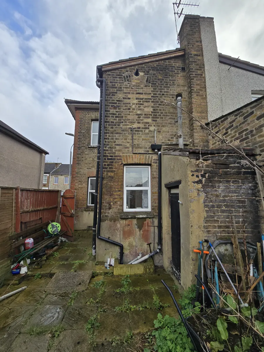 Rear yard and two-storey rear outrigger in London stock brick, existing single-storey lean-to