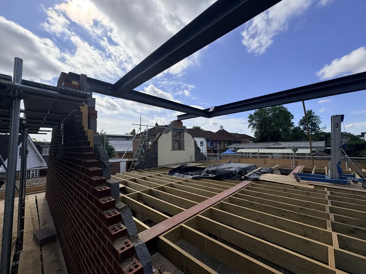 New steel beam frame over the timber floor joists during construction