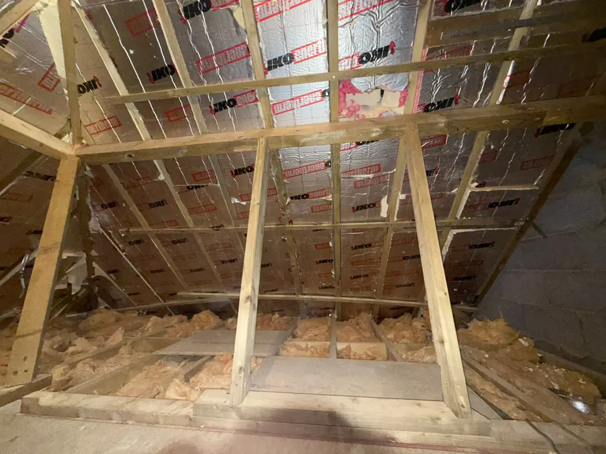 Roof void with new purlins, collar and raking struts against the party wall