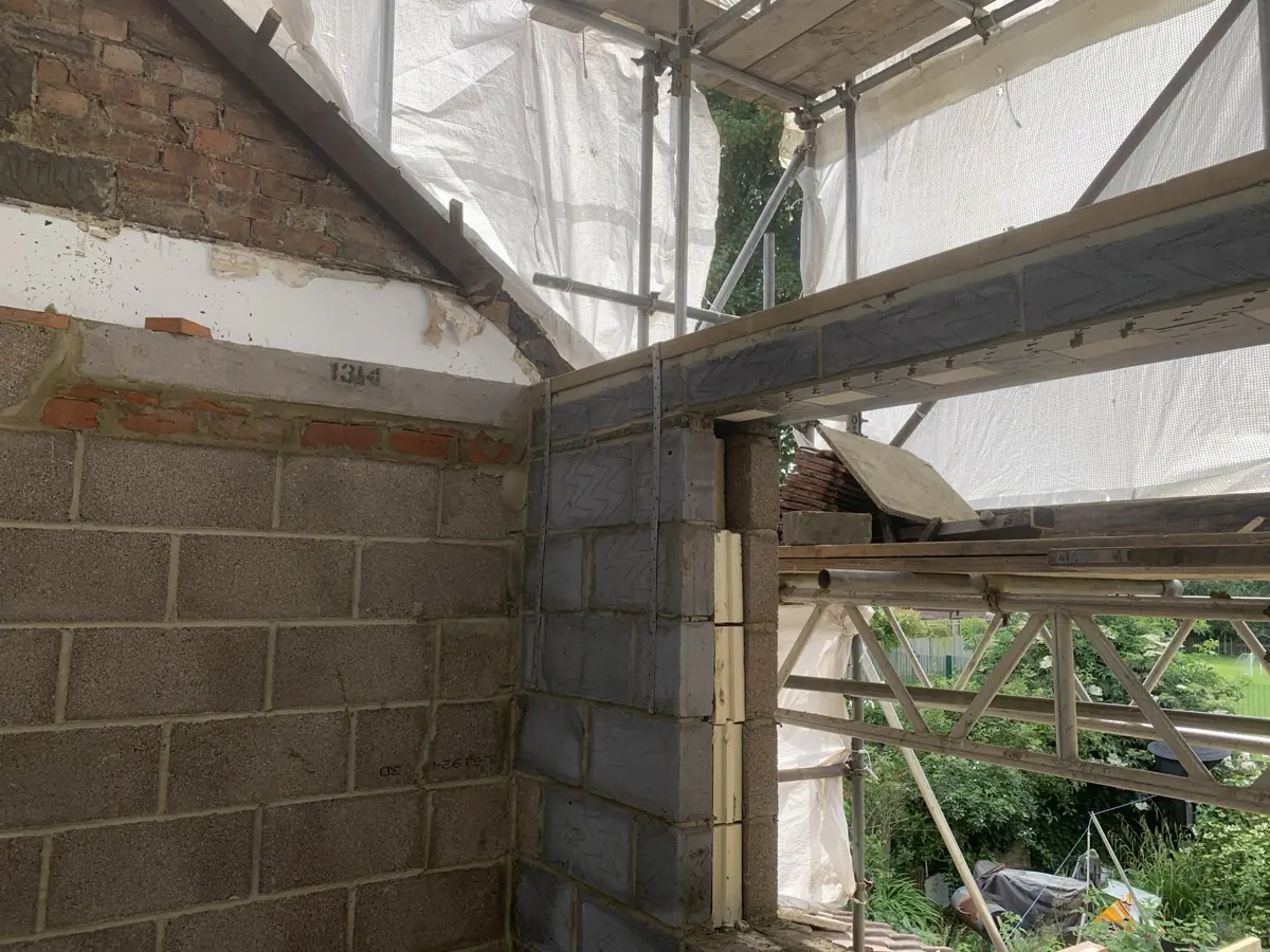 Dormer cheek wall in blockwork built against existing brick party/gable wall, lintel and restraint straps